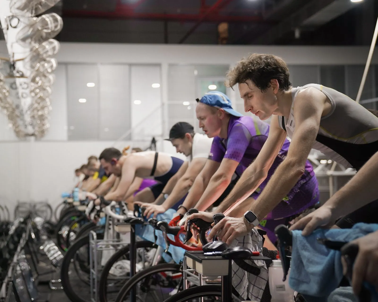 Athletes engaged in a high-intensity indoor cycling session, enhancing fitness and endurance.